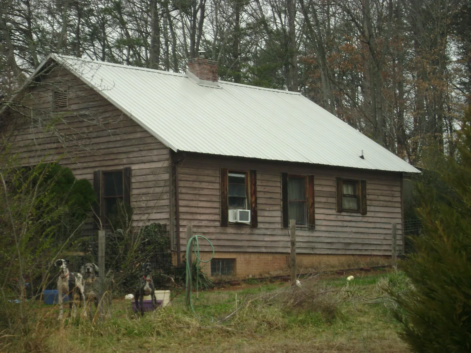 White metal roof on an old wood sided farmhouse, from a Metal Roof Installation job in Belchertown